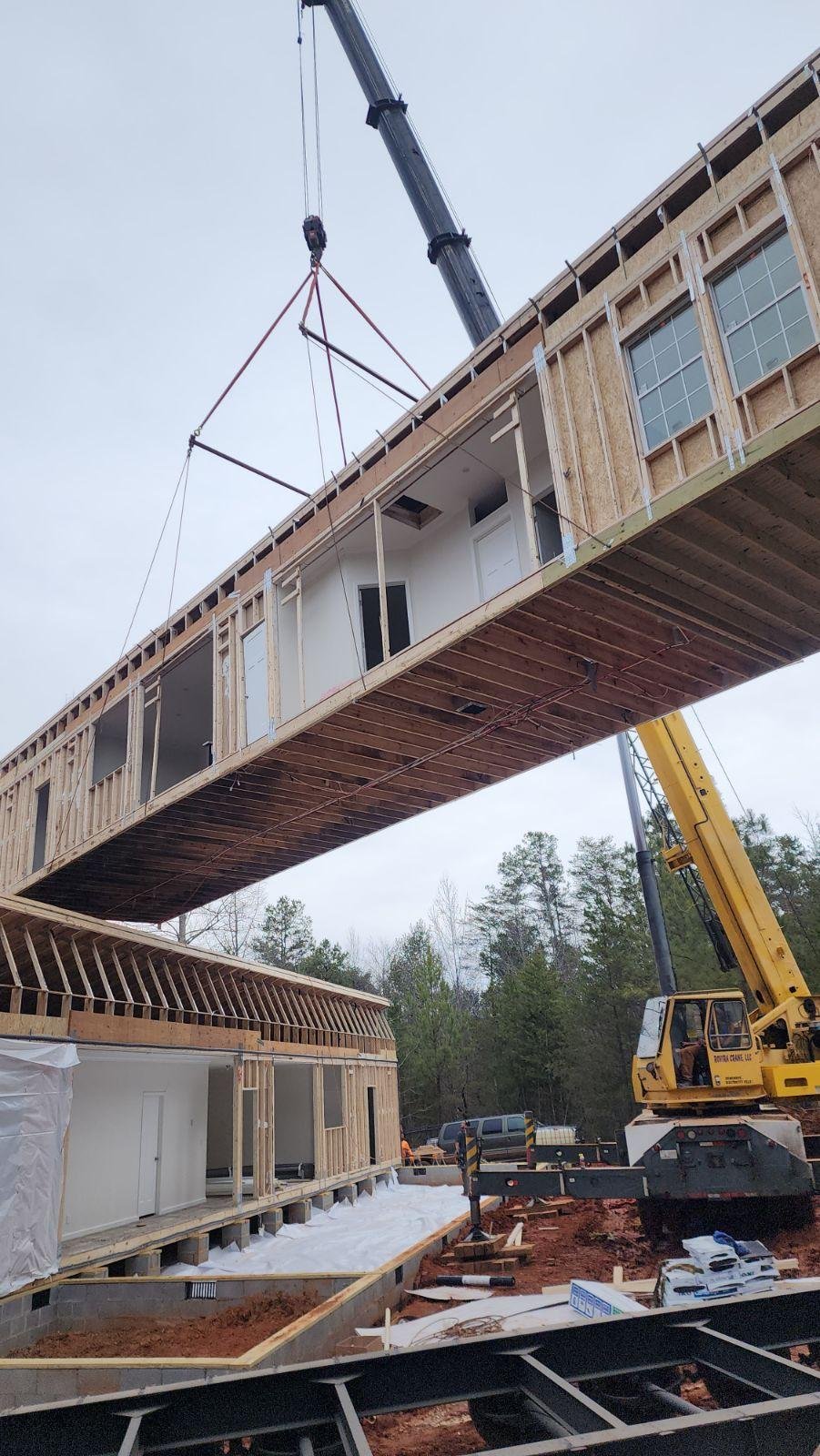 Modular home being set with a crane